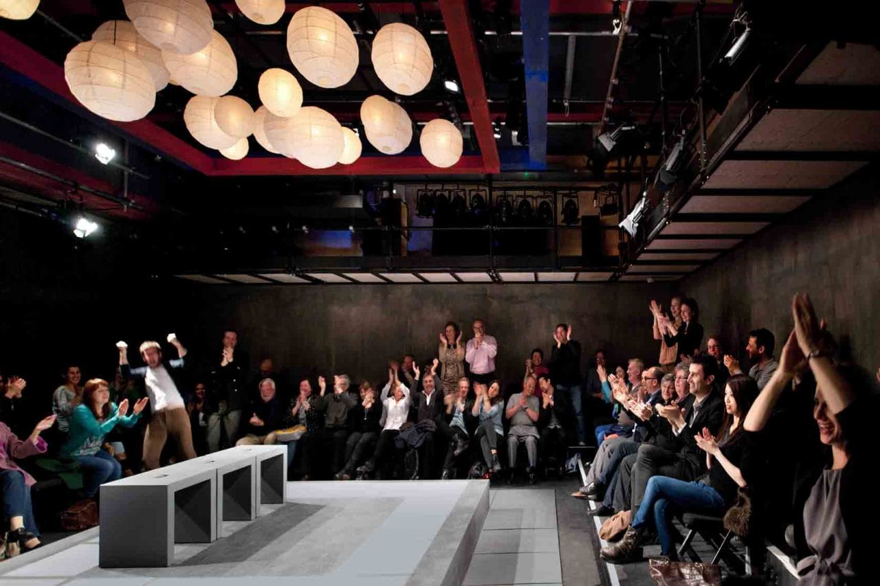 Inside the Park 90 Theatre with the audience clapping after a performance.