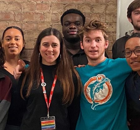 A group of young adults smiling for a group photo