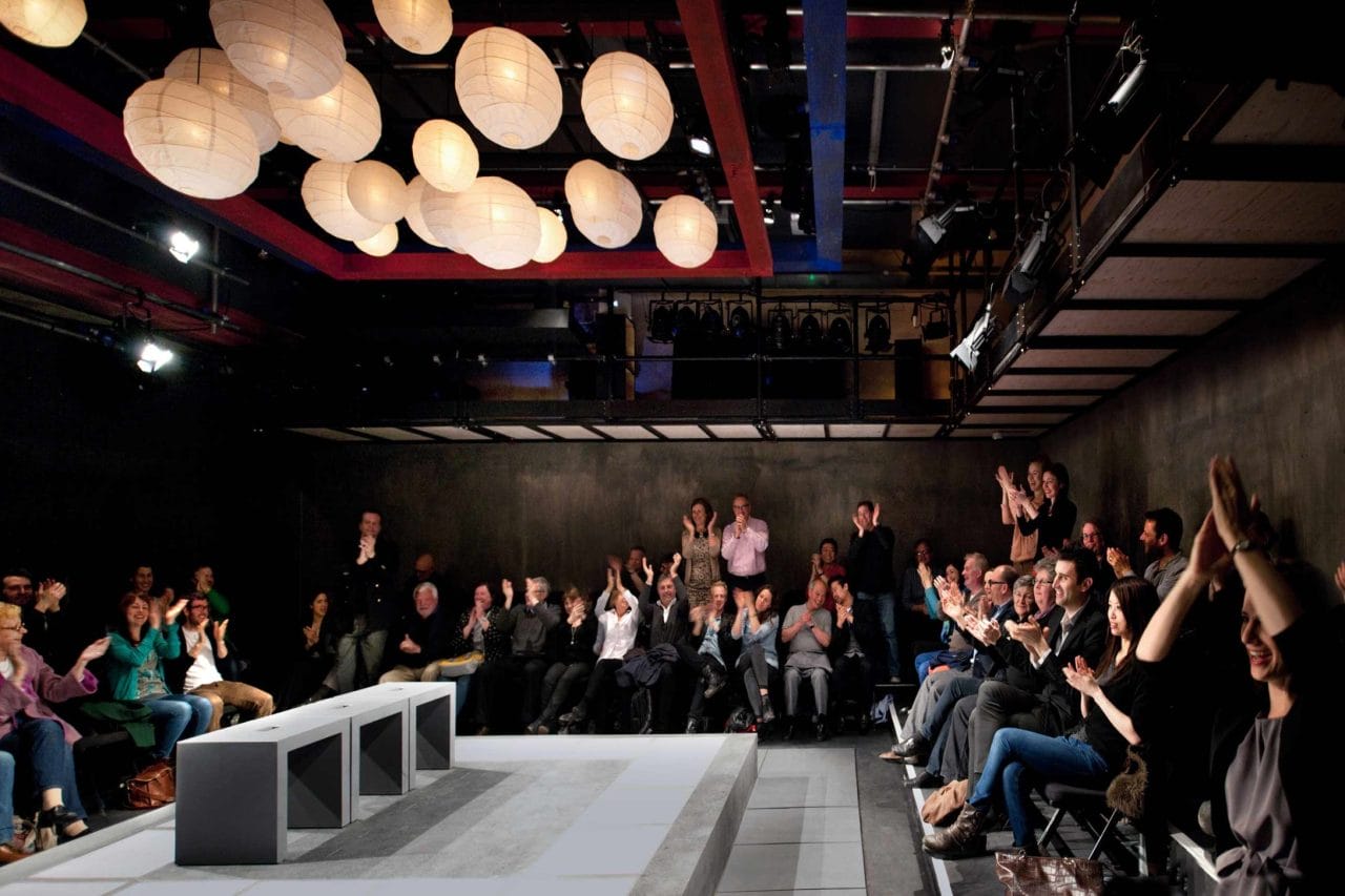 Inside the Park 90 Theatre with the audience clapping after a performance.