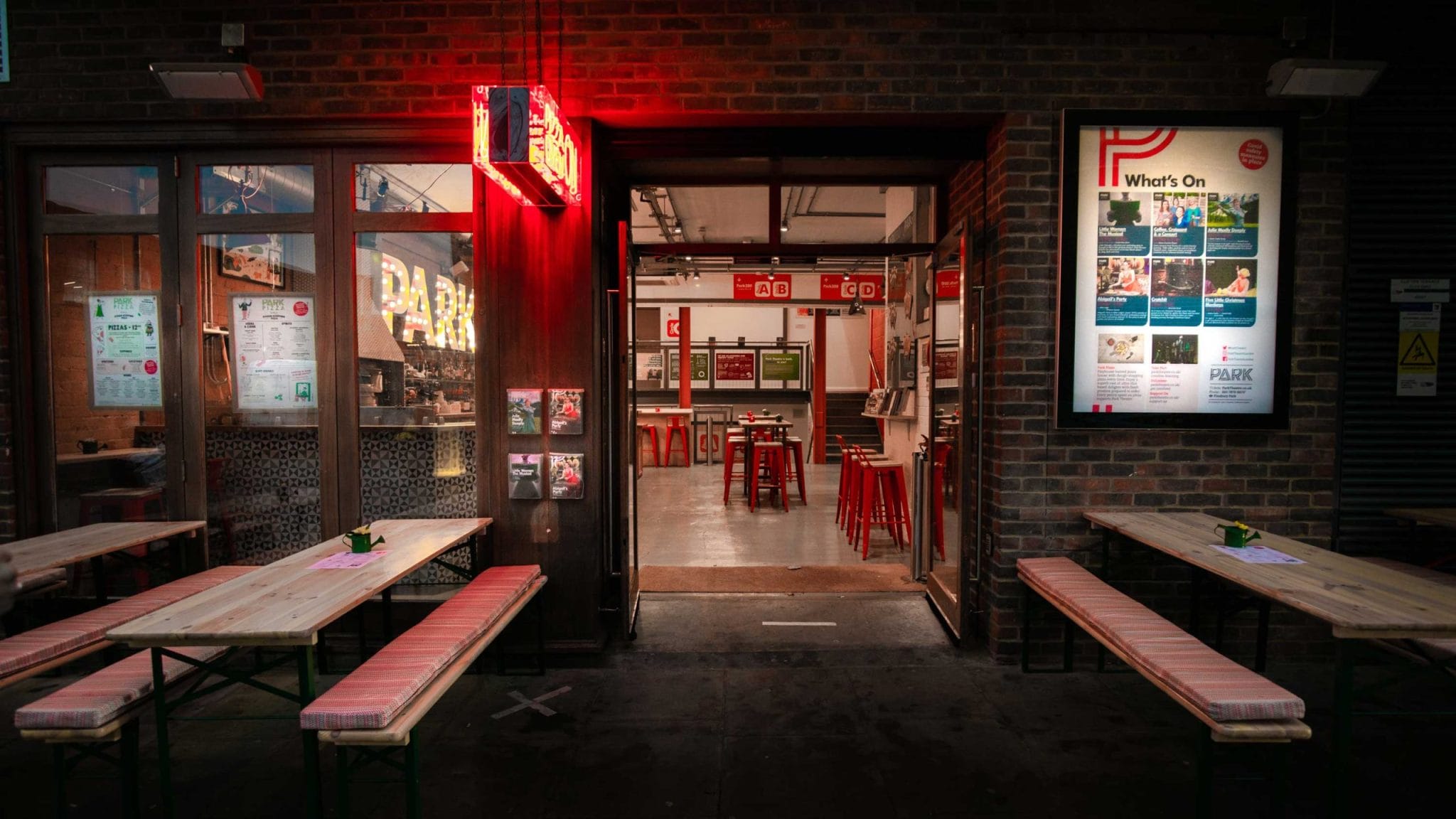 Park Theatre Building, looking at outside seating with a view into the lower level of the building where the downstairs bar is