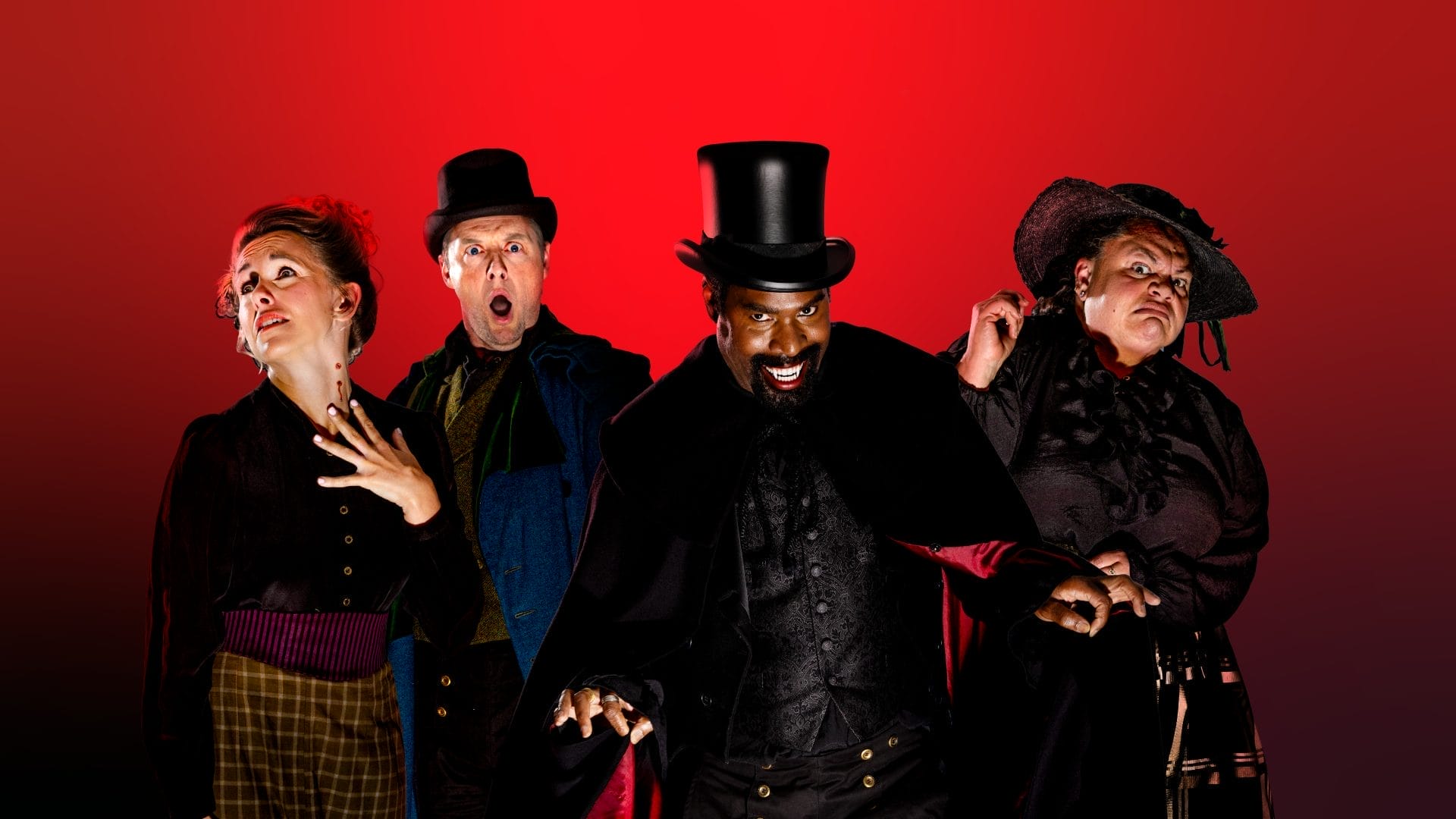 The cast of Dracapella stand in front of a dark red background. Ako Mitchell is in the centre wearing a black top hat and cloak, grinning to show his fangs. Keala Settle is to his right, wearing a black hat and dress, she is grimacing at the camera. Stephen Ashfield is on his left, with a shocked expression. He wears a black top hat and blue jacket. Lorna Want stands in front of Stephen, her head is turned to the left to show a bite on her neck. She wears a black jacket and brown and yellow skirt.