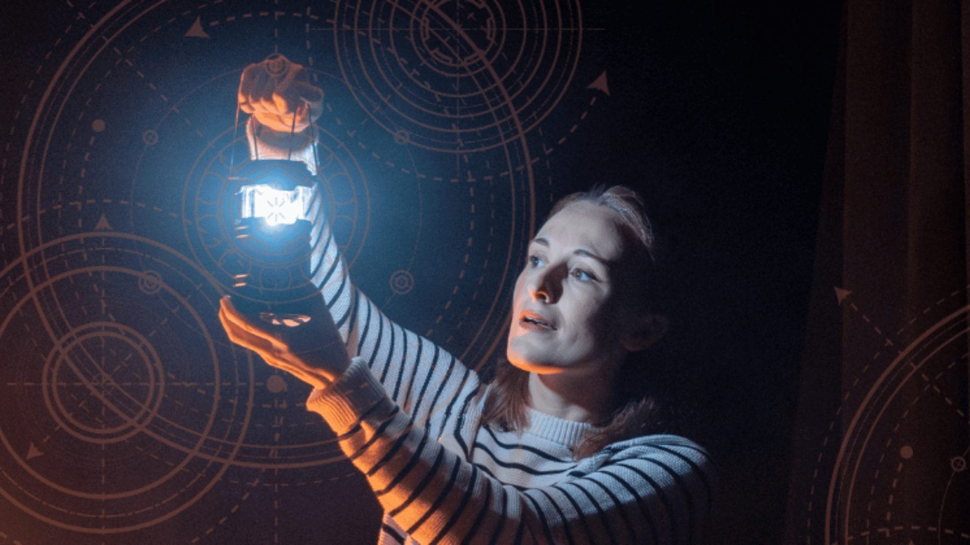 Woman holds a hand-held modern lantern just above her eyeline as she looks towards it. Circles and dotted arrow pattern is faintly seen in the background.